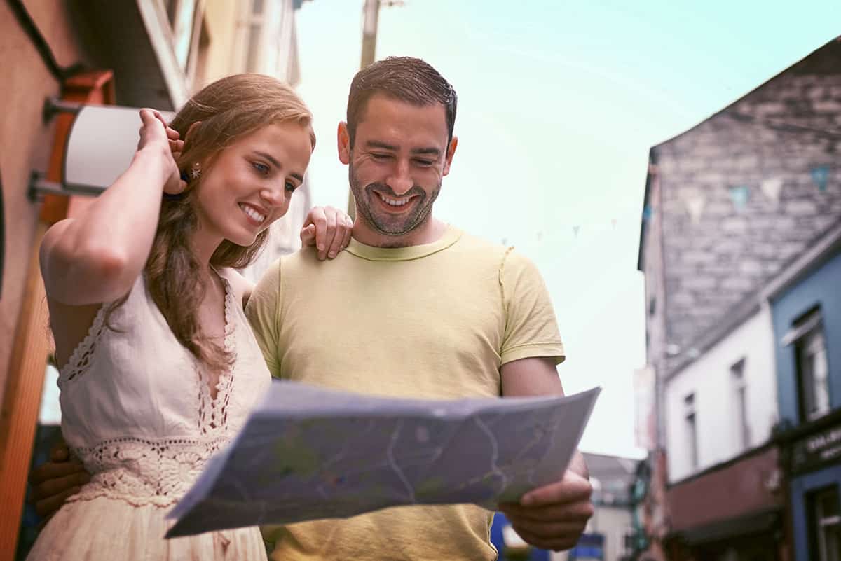 A couple in the street reading a property map, Millennials Choosing to Rent Instead of Buying a Property.